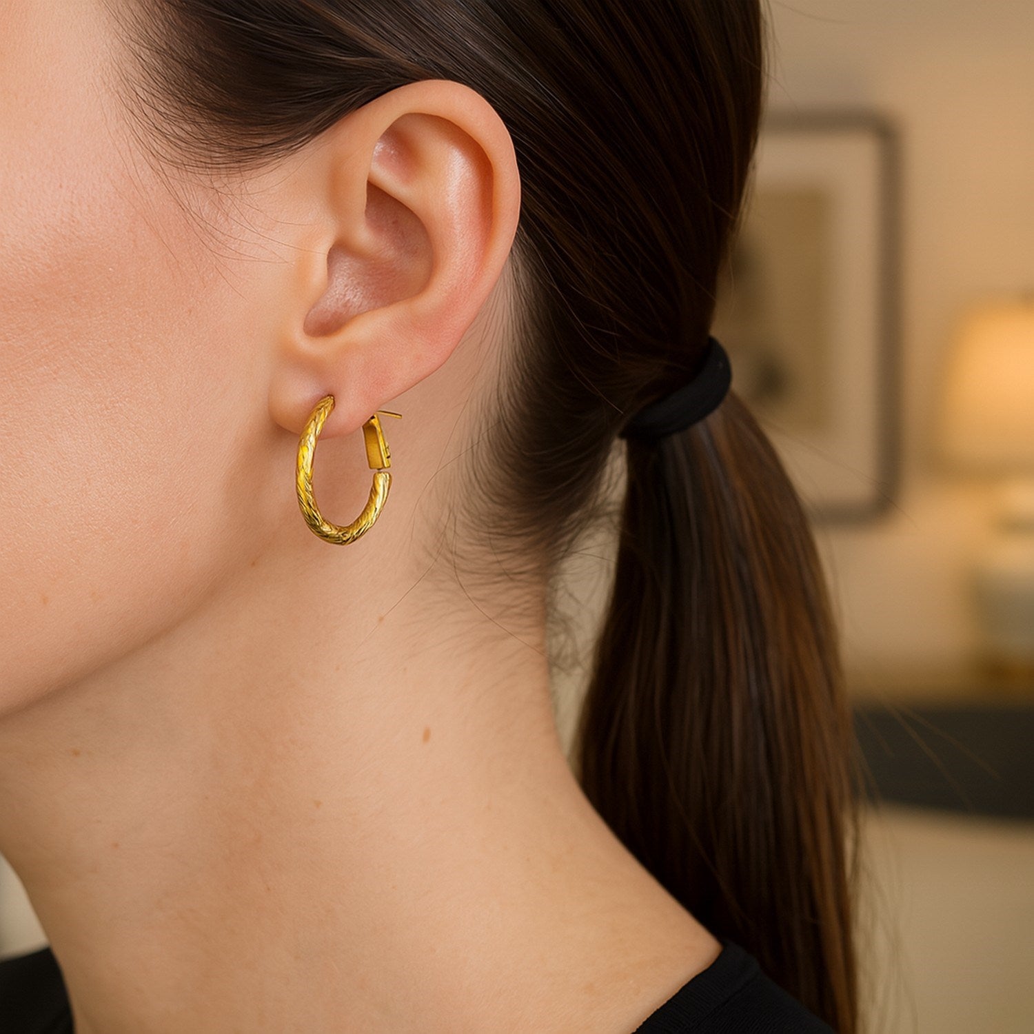 14k yellow gold petite twisted hoop earrings with a modern design, perfect for elegant everyday wear.