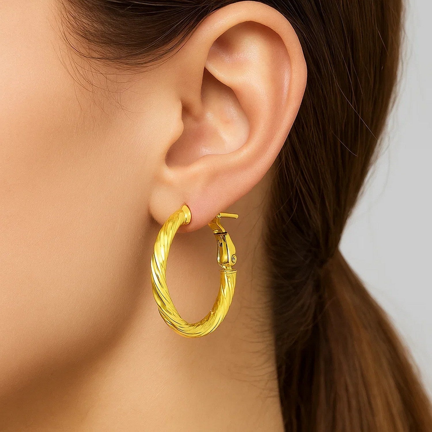 14k yellow gold petite twisted hoop earrings with modern design and elegant round shape for a luxurious touch.