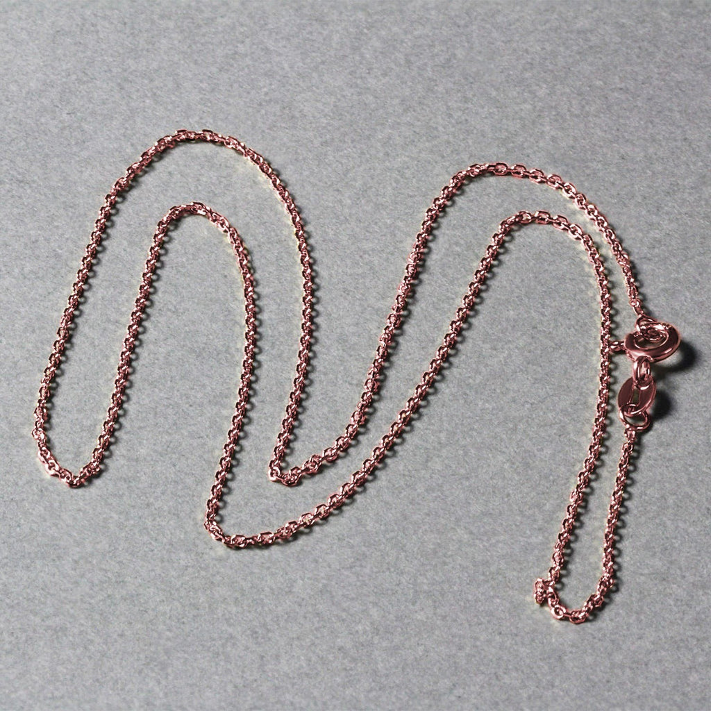 Elegant 18k rose gold diamond cut cable link chain, featuring refined links and a luxurious shine, perfect for layering.