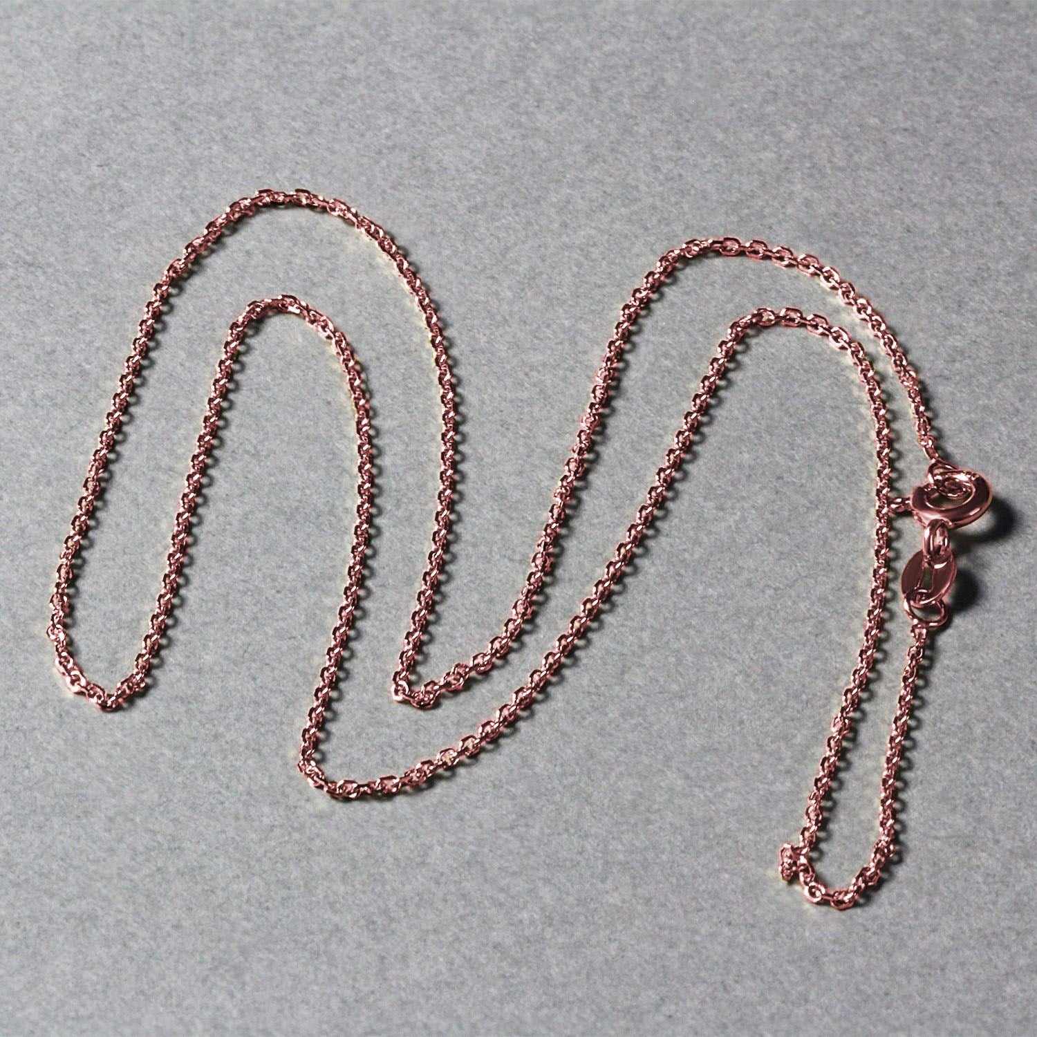 Elegant 18k rose gold diamond cut cable link chain, featuring refined links and a luxurious shine, perfect for layering.