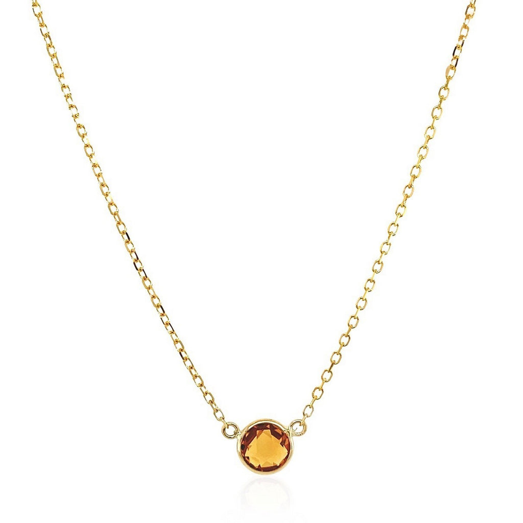 Elegant 14k yellow gold necklace featuring a round citrine on a delicate chain, perfect for sophisticated style.