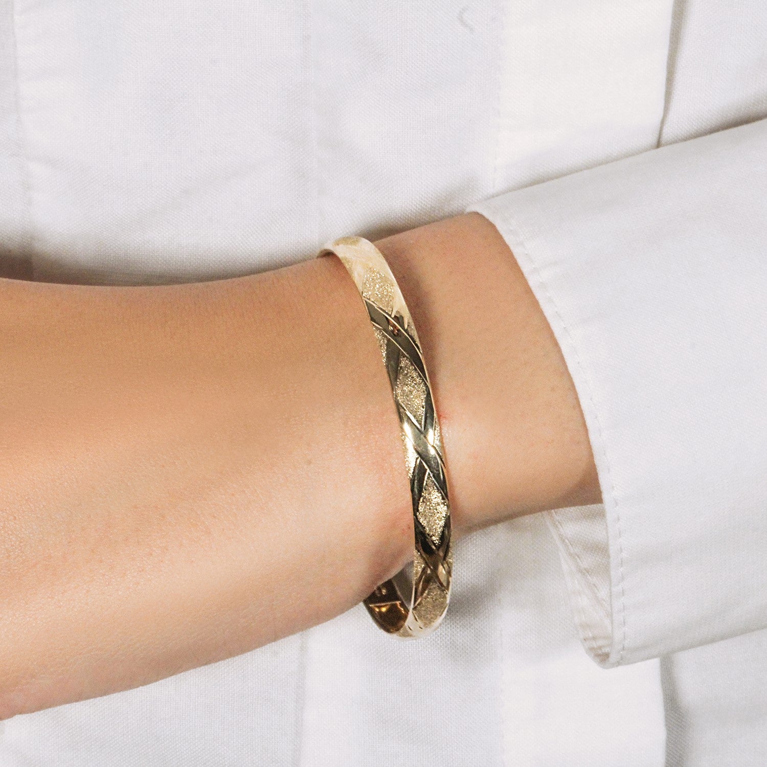 10k yellow gold textured bangle featuring a modern diamond pattern, elegantly crafted for luxury appeal.