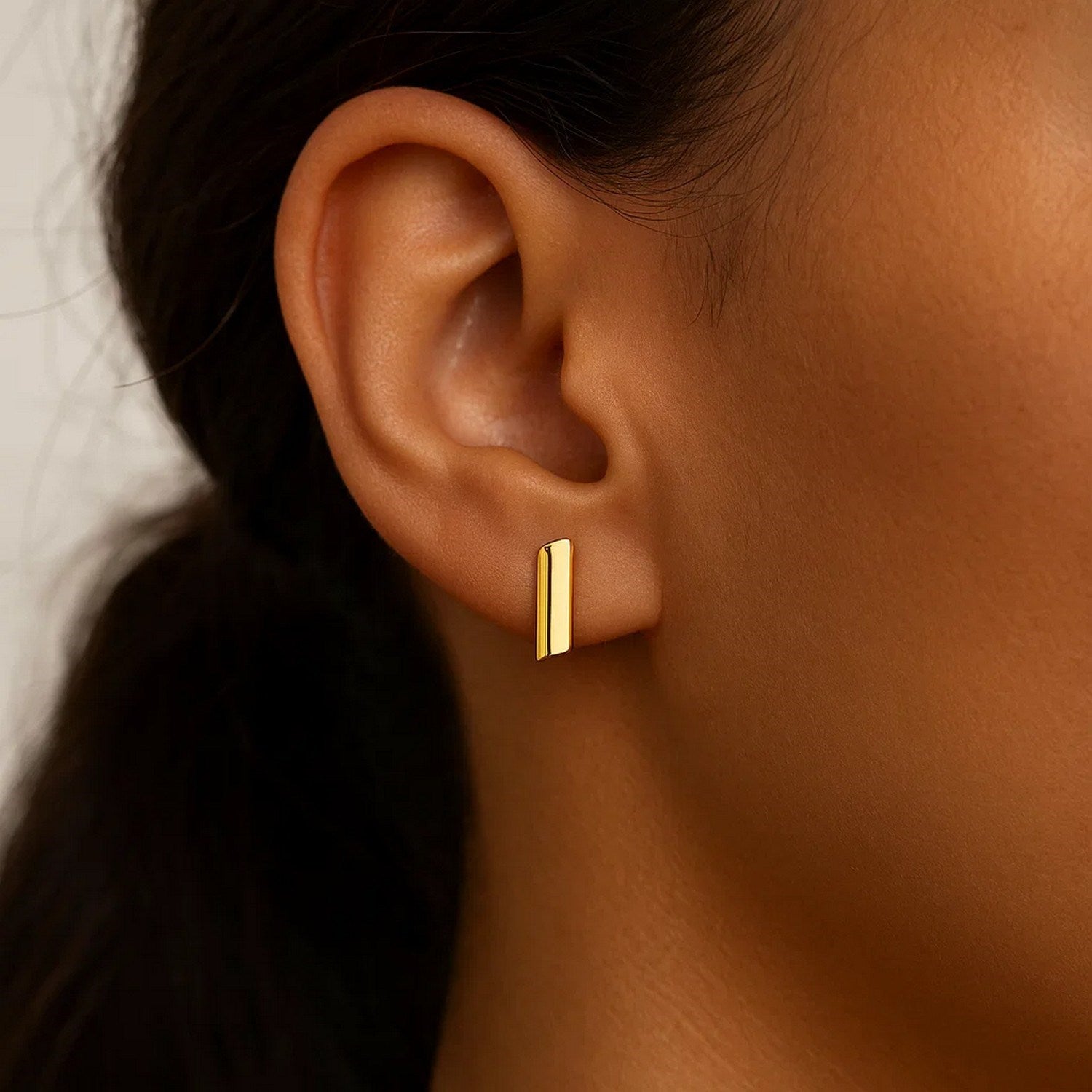 14k yellow gold polished rectangular earrings showcasing a modern design with a luxurious finish.