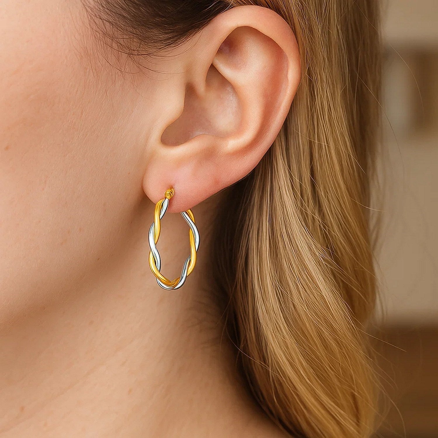 14k two-tone twisted wire hoop earrings in yellow and white gold, showcasing a modern and elegant design.