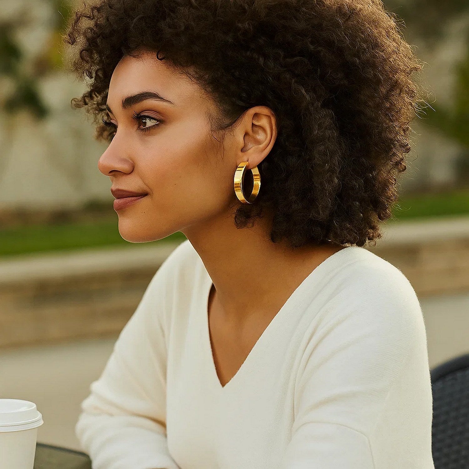 14K yellow gold large tube hoop earrings with a modern design, showcasing elegance and timeless sophistication.