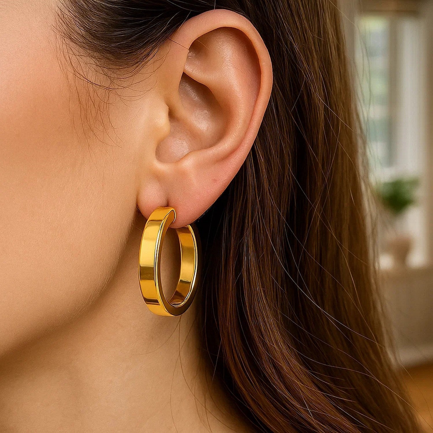 14k yellow gold large tube hoop earrings with a modern design, showcasing elegance and timeless sophistication.