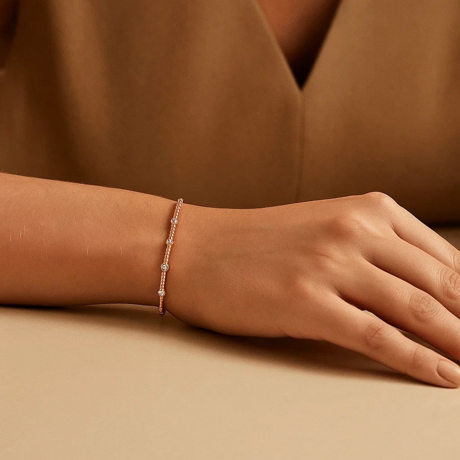 Classic 14k rose gold beaded bracelet featuring a delicate chain design, perfect for elegant layering or solo wear.
