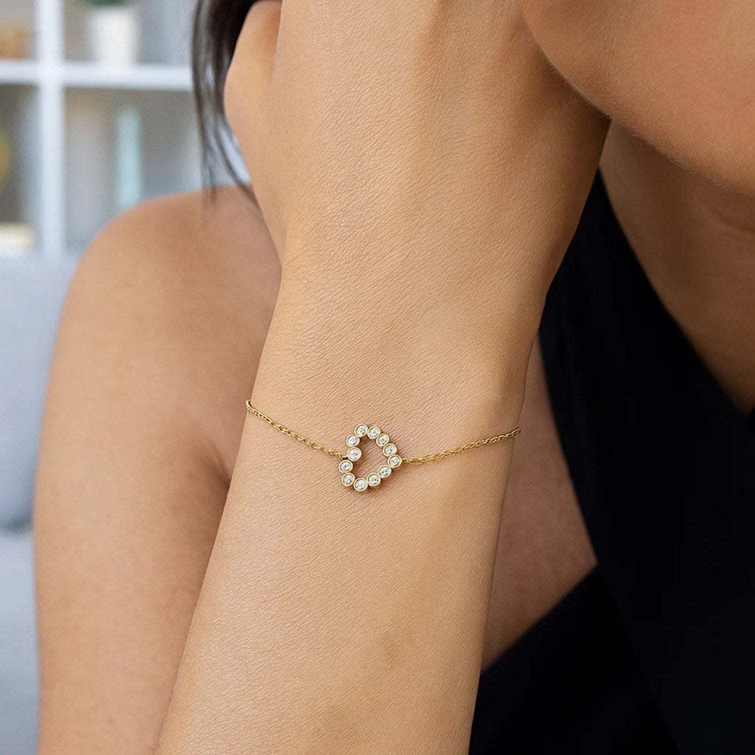 Elegant 14k yellow gold petite diamond heart bracelet with a delicate chain, perfect for refined luxury style.
