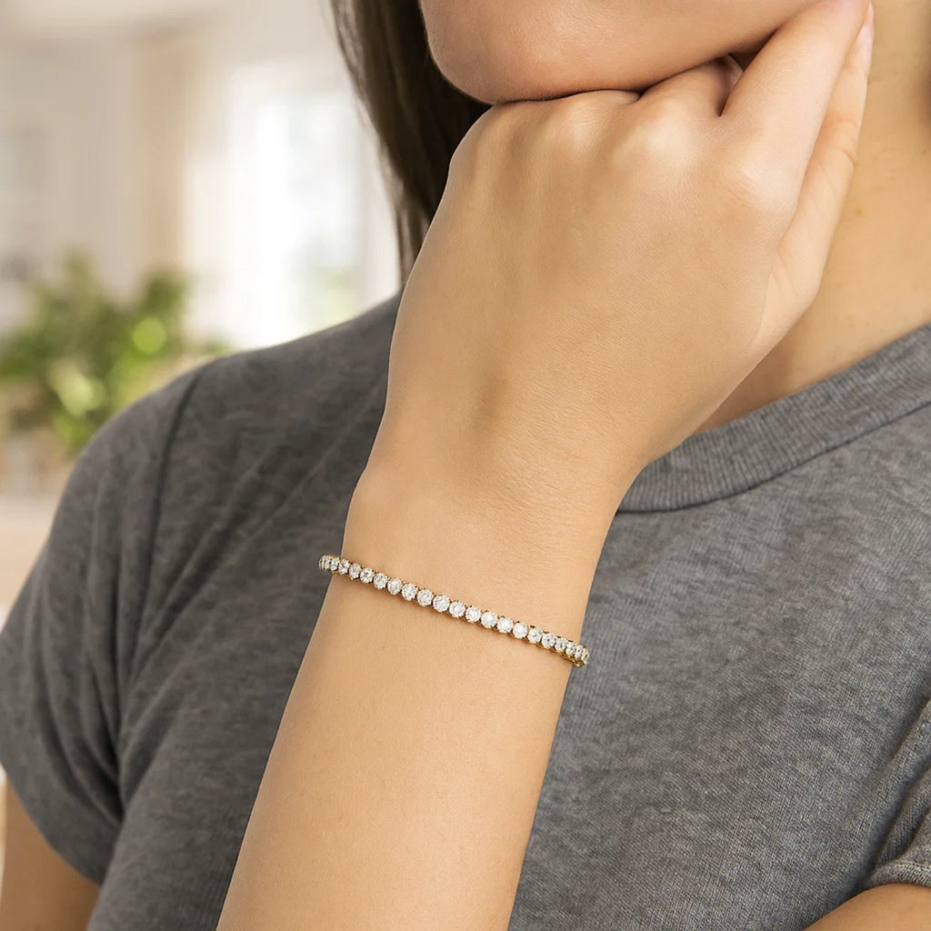14K two-tone gold tennis bracelet featuring round diamonds, exuding elegance and timeless luxury.